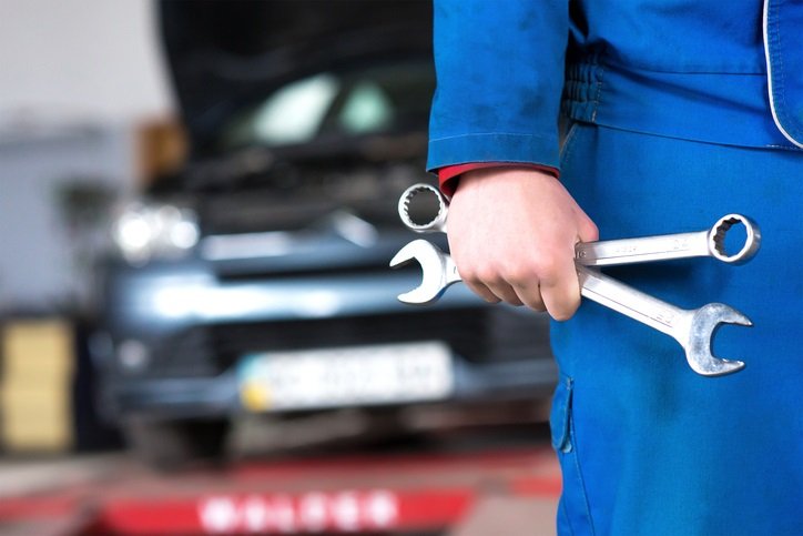 Hand of car mechanic with wrench