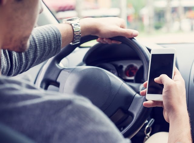 man texting while driving, distracted driving