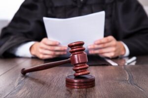 Judge In Front Of Mallet Holding Documents