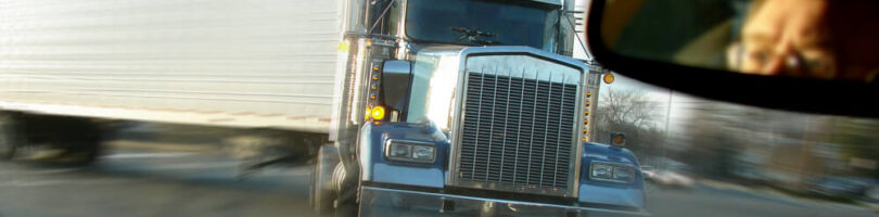tractor trailer making too wide of a turn about to run into car