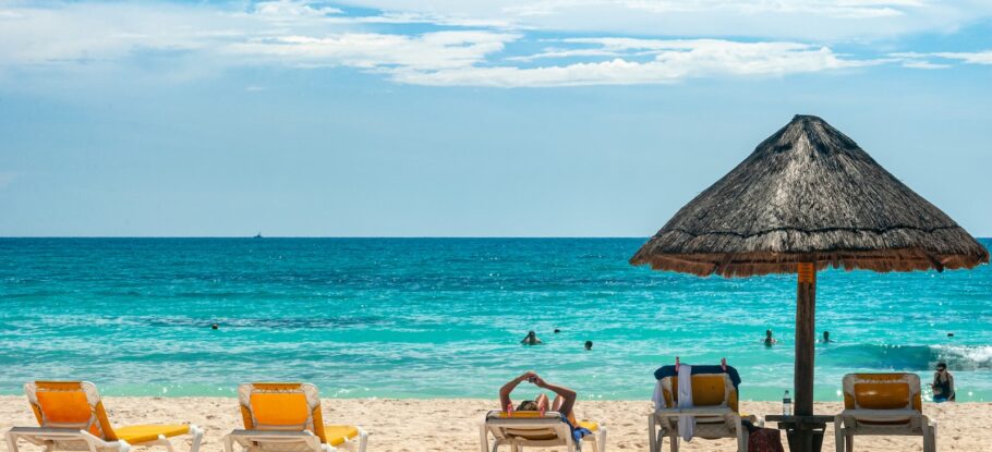 brown beach umbrellas on beach during daytime