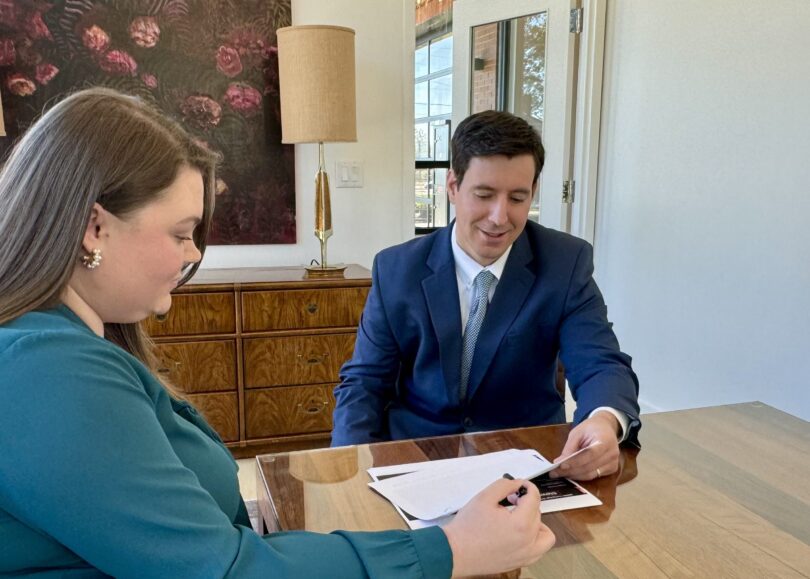 Attorney Brett Lonadier discussing a case with paralegal