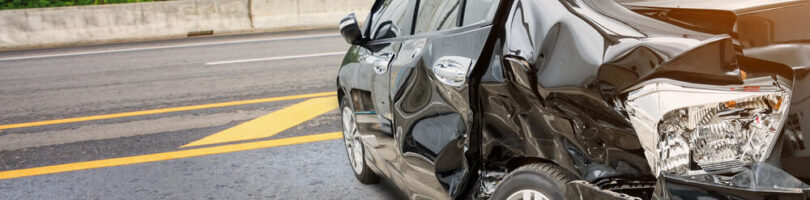 Black car hit on drivers side with extreme damage